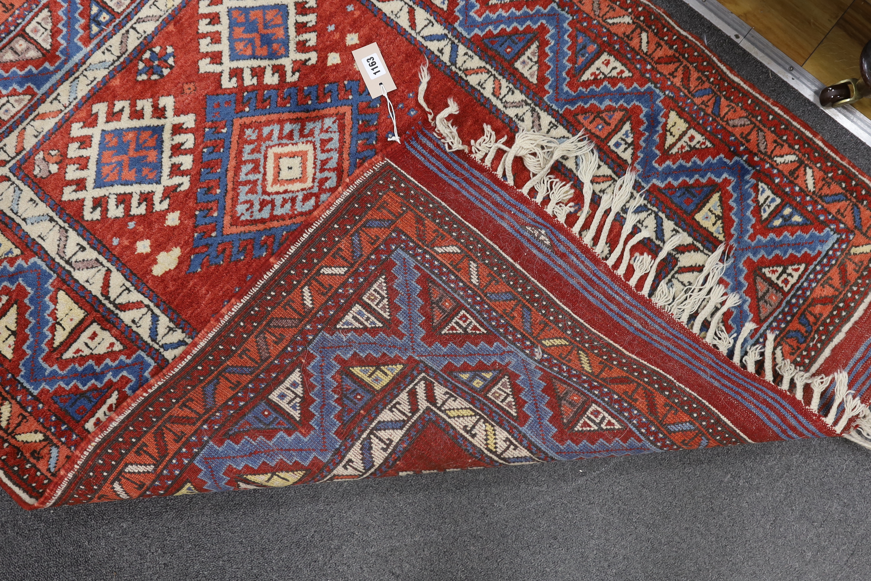 A Turkish red ground rug, 134 x 99cm